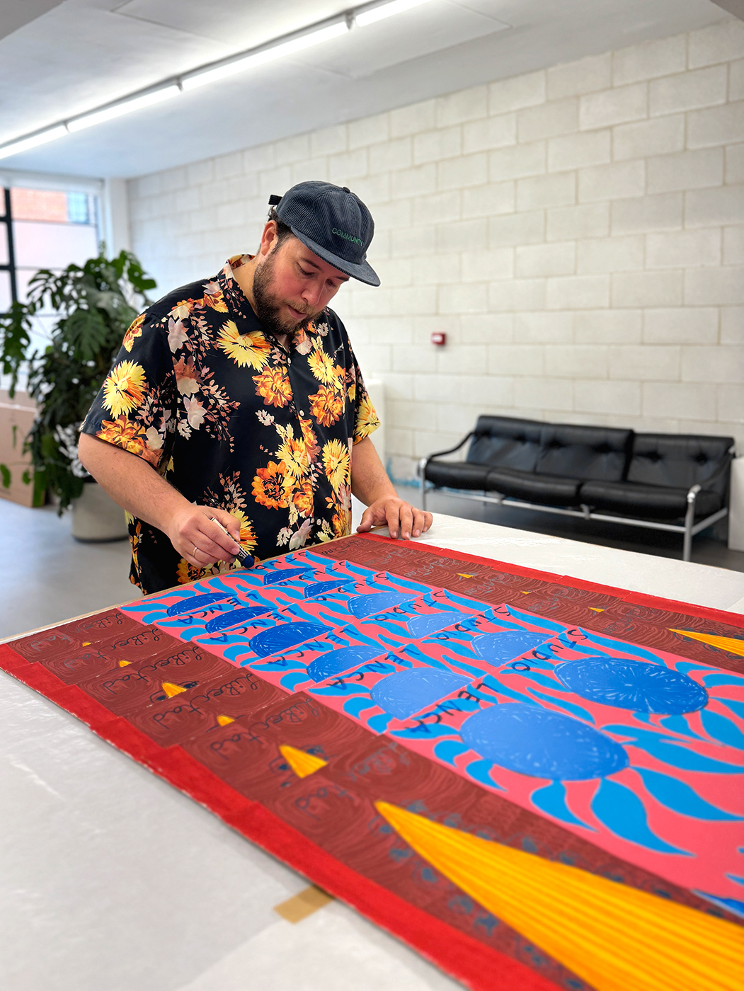 Studio Lenca hand-applying oil stick to each 'Libertad' print