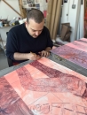 Anthony Cudahy signing his prints at his studio in Brooklyn, New York.