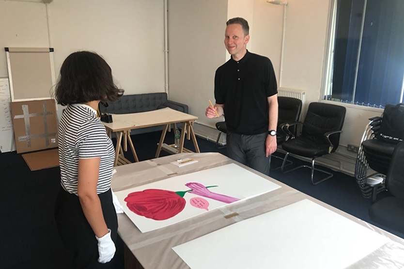 The artist signing his print