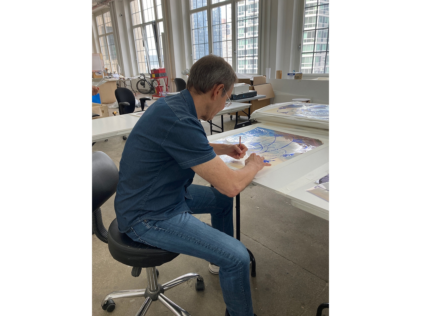 Jeff Koons signs 'Carracci Flower' (2021) in his studio, New York, 2021.