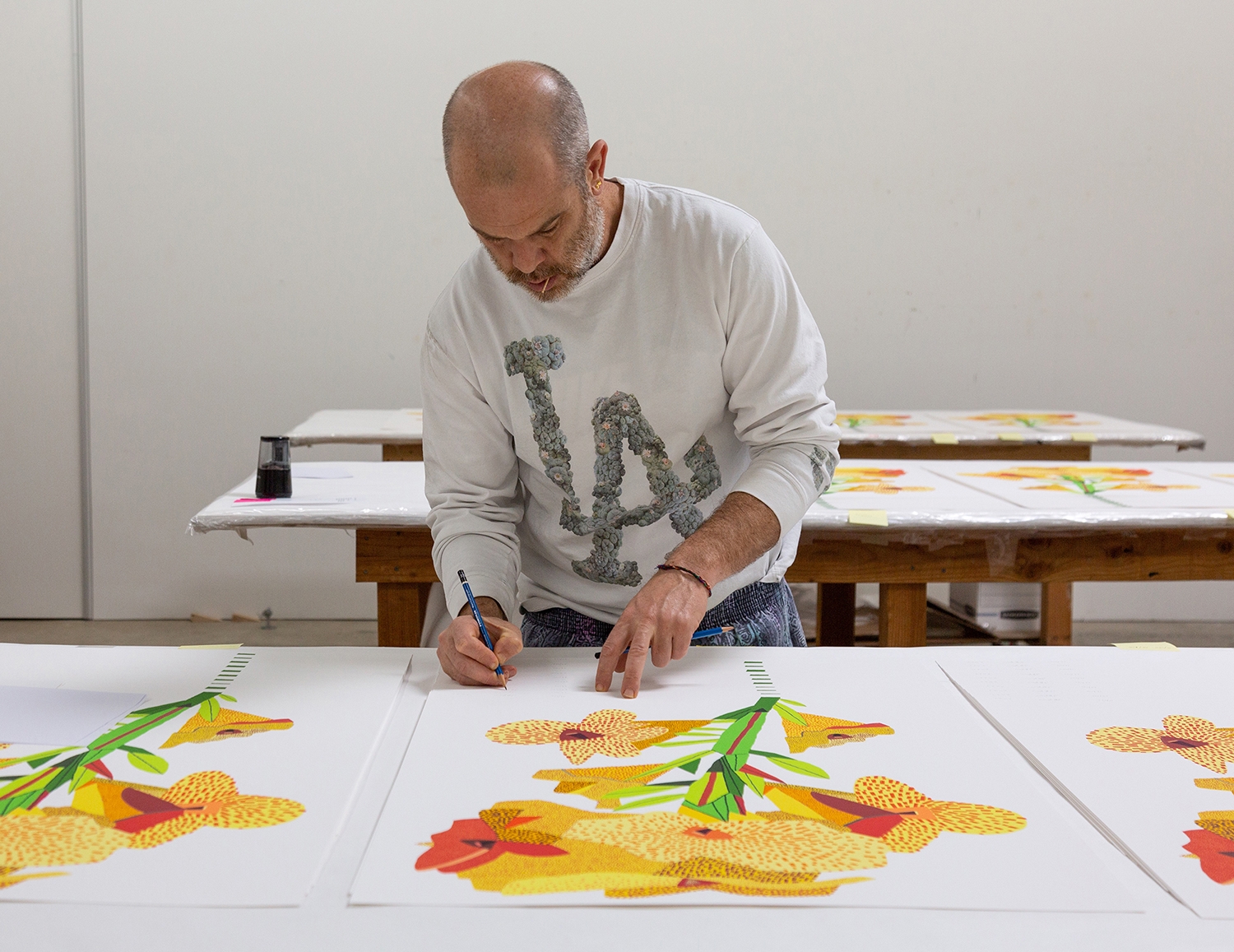Jonas Wood signing his prints for GREENPEACE 50 YEARS