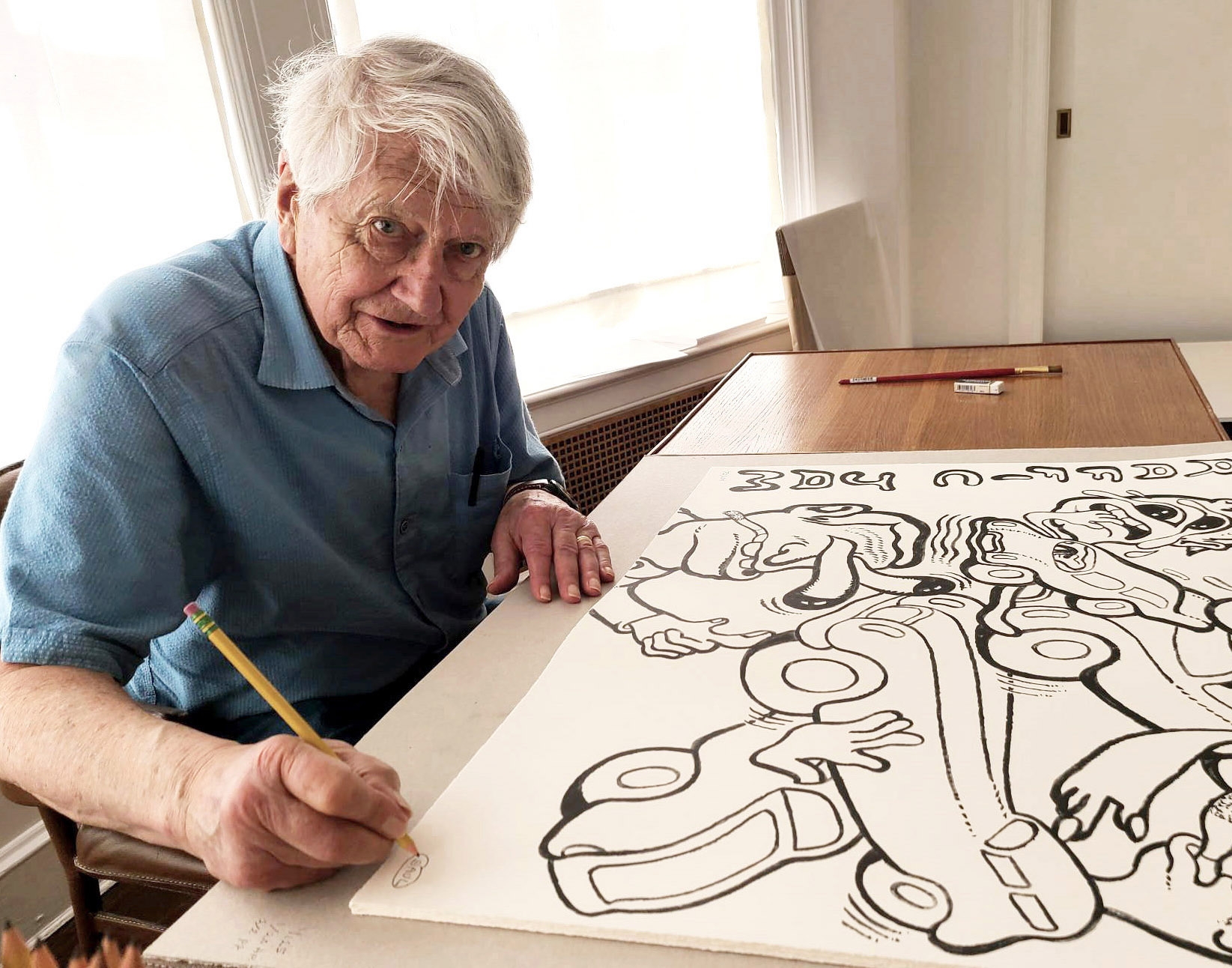 Peter Saul signing his print for GREENPEACE 50 YEARS (2022)
