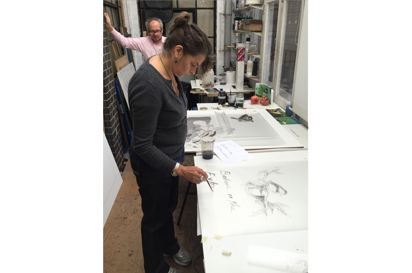 Tracey building up the composition of work by adding text on a separate layer of film
