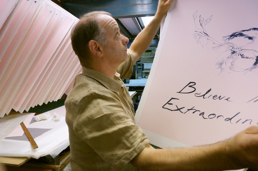 Hanging prints from the ball drying racks after printing