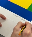 The artist signing his print 