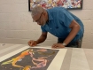 Chris Ofili signing his print