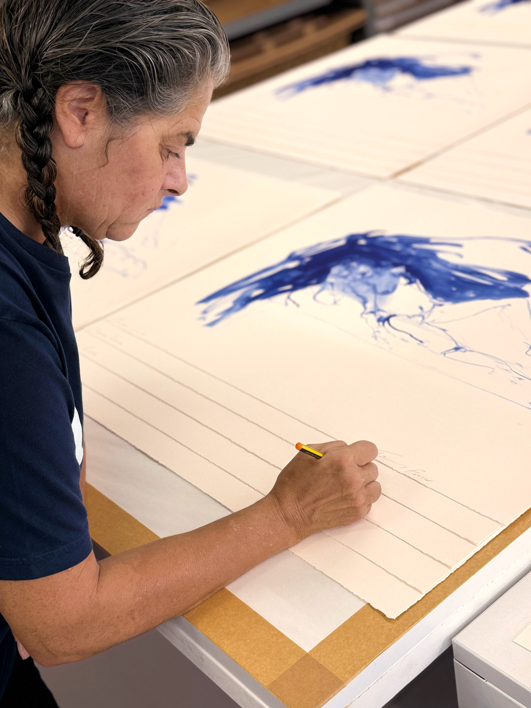 Tracey Emin signing her prints