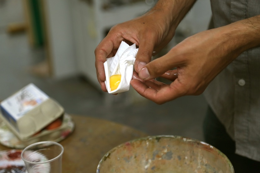 Benjamin separates egg yolks from whites to hand-make his egg tempera paint