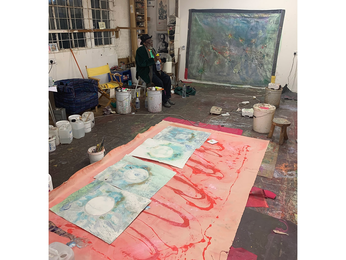 Artist Frank Bowling in his London studio selecting source artwork for the project (2019)