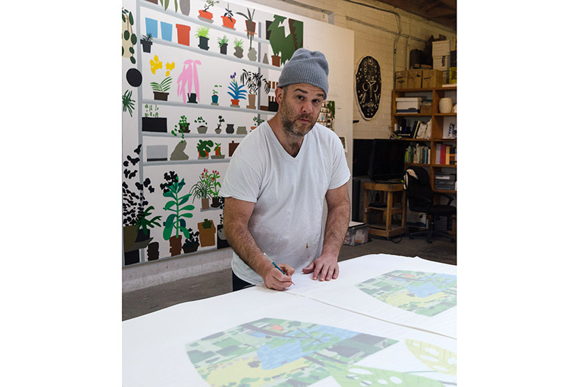 Jonas signs the prints in his New York studio
