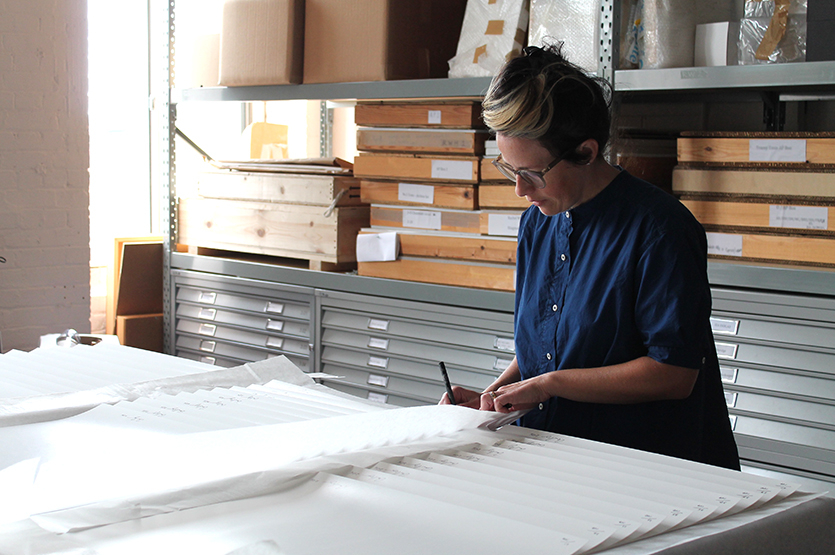 Anne Hardy signing, dating and numbering all the one hundred of the prints in the edition