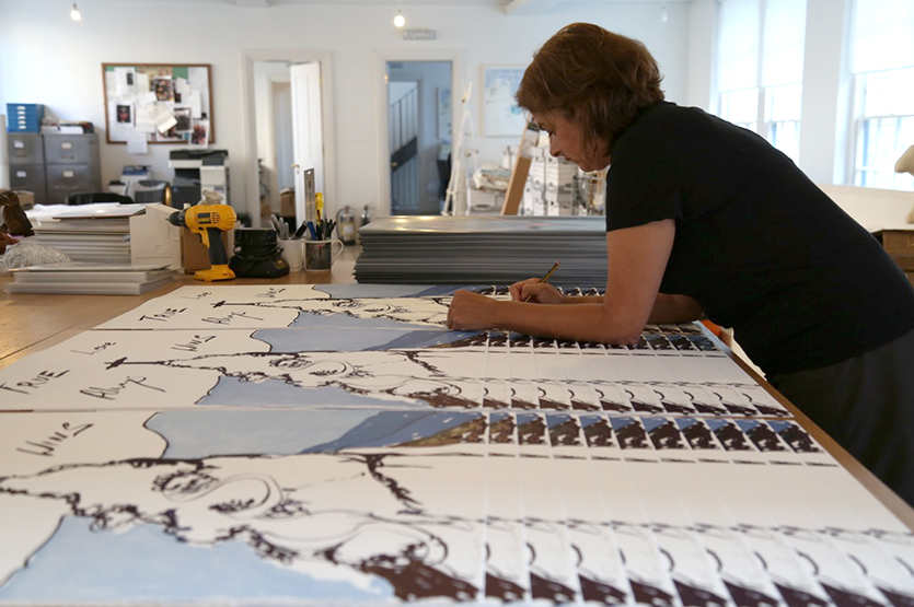 Tracey signs and numbers the prints at her studio