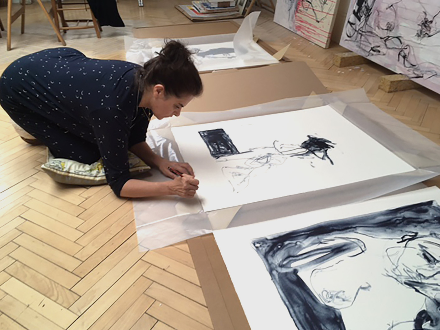 Tracey signing the prints in her studio, London (2021)