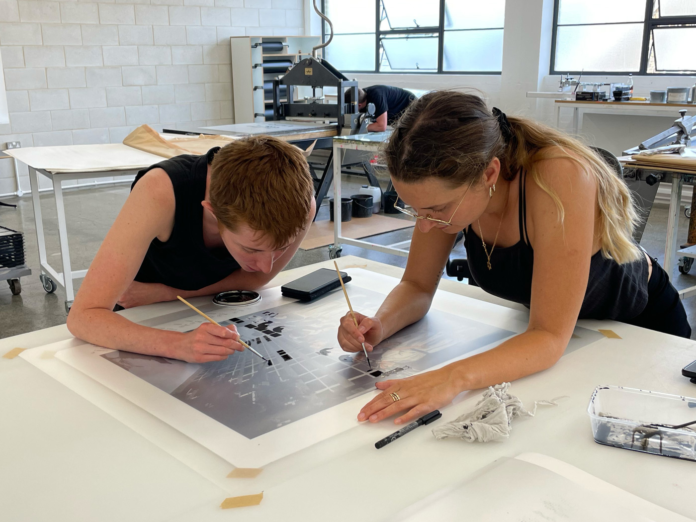 Hannah Quinlan and Rosie Hastings working on their print at Counter Studio, Margate