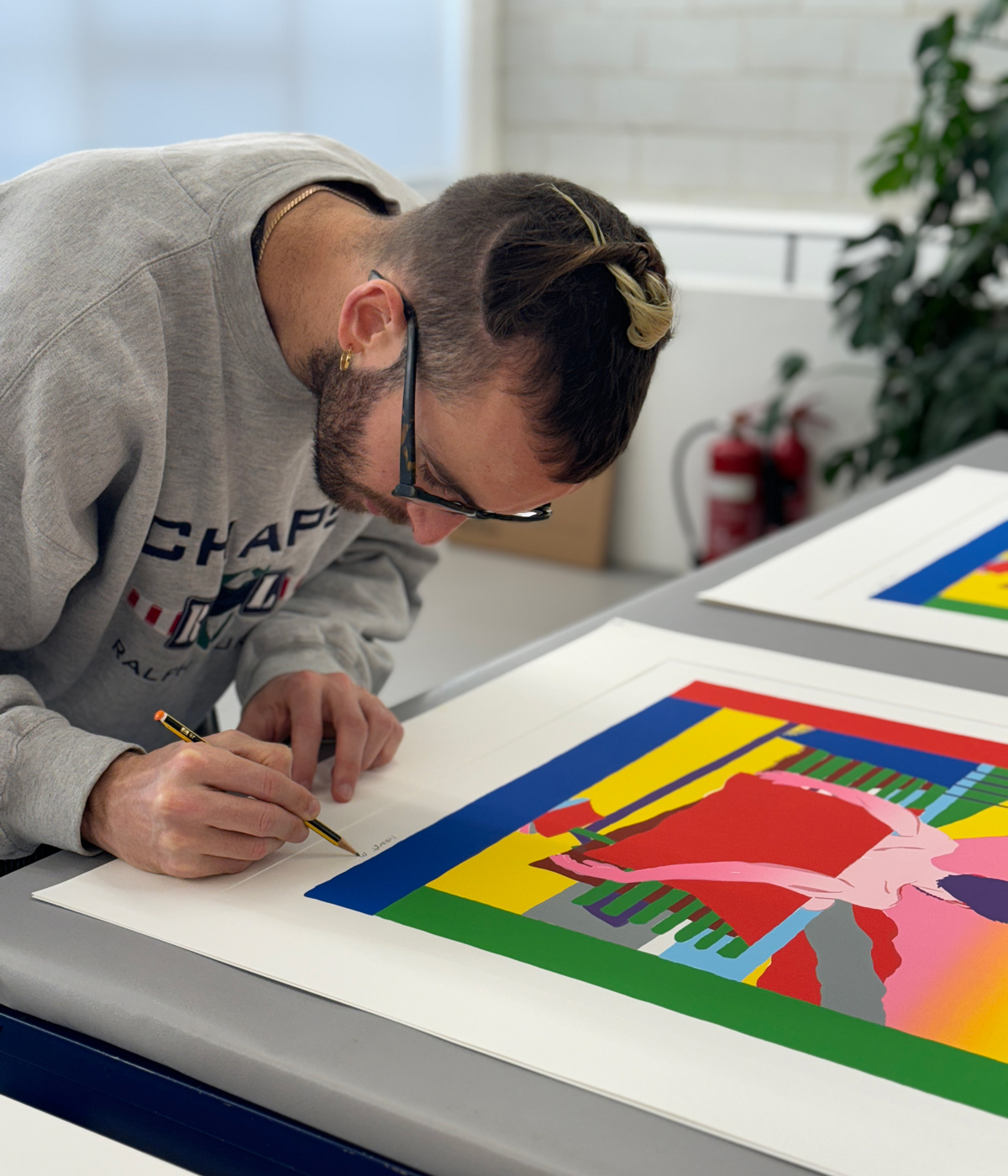 The artist signing his print 
