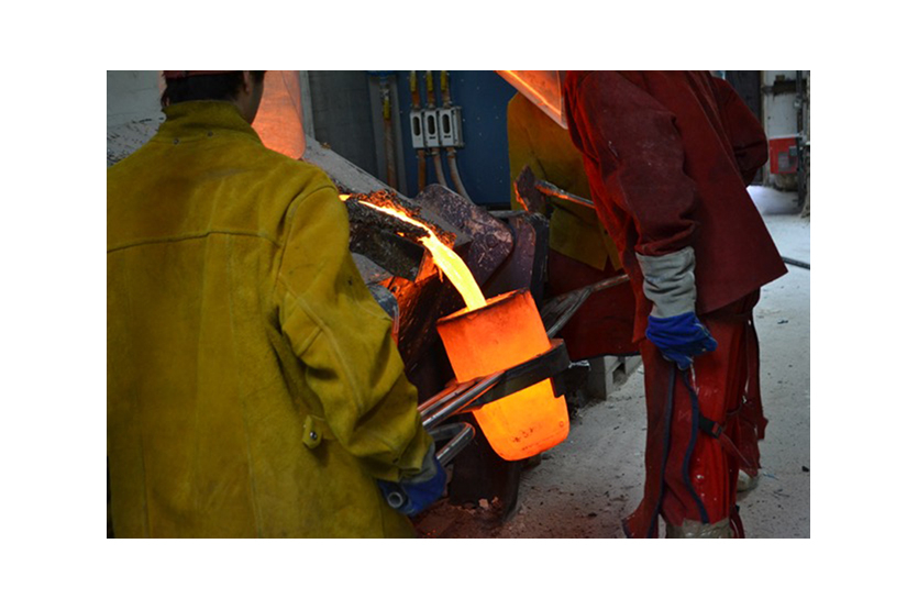 Molten bronze being prepared for casting