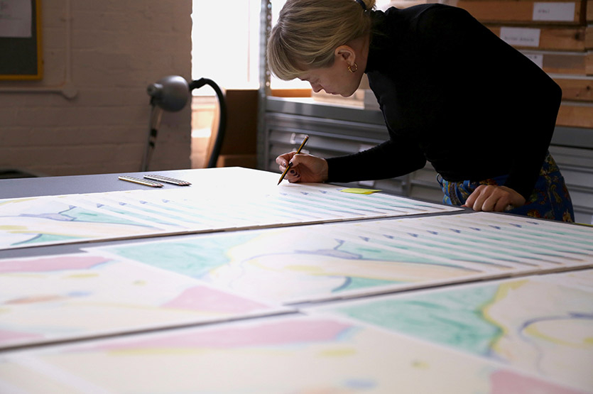 Celia signs the prints at Counter's studio space