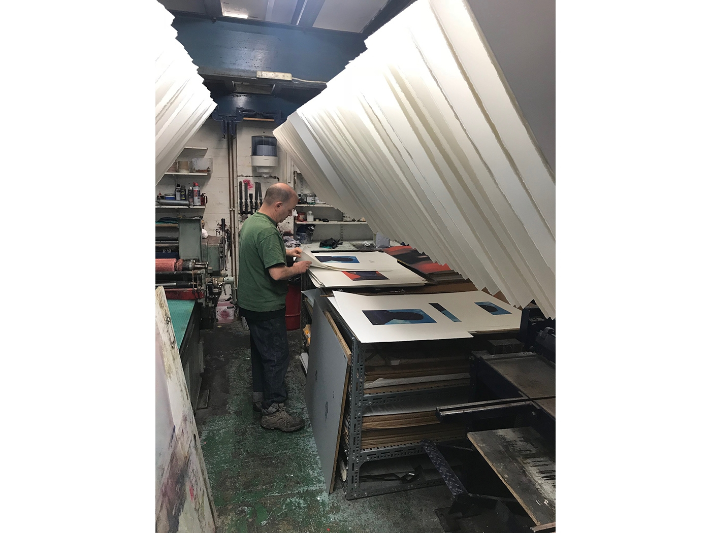 Mike Taylor inspecting each of the fine art lithographs at Pauper's Press, London.